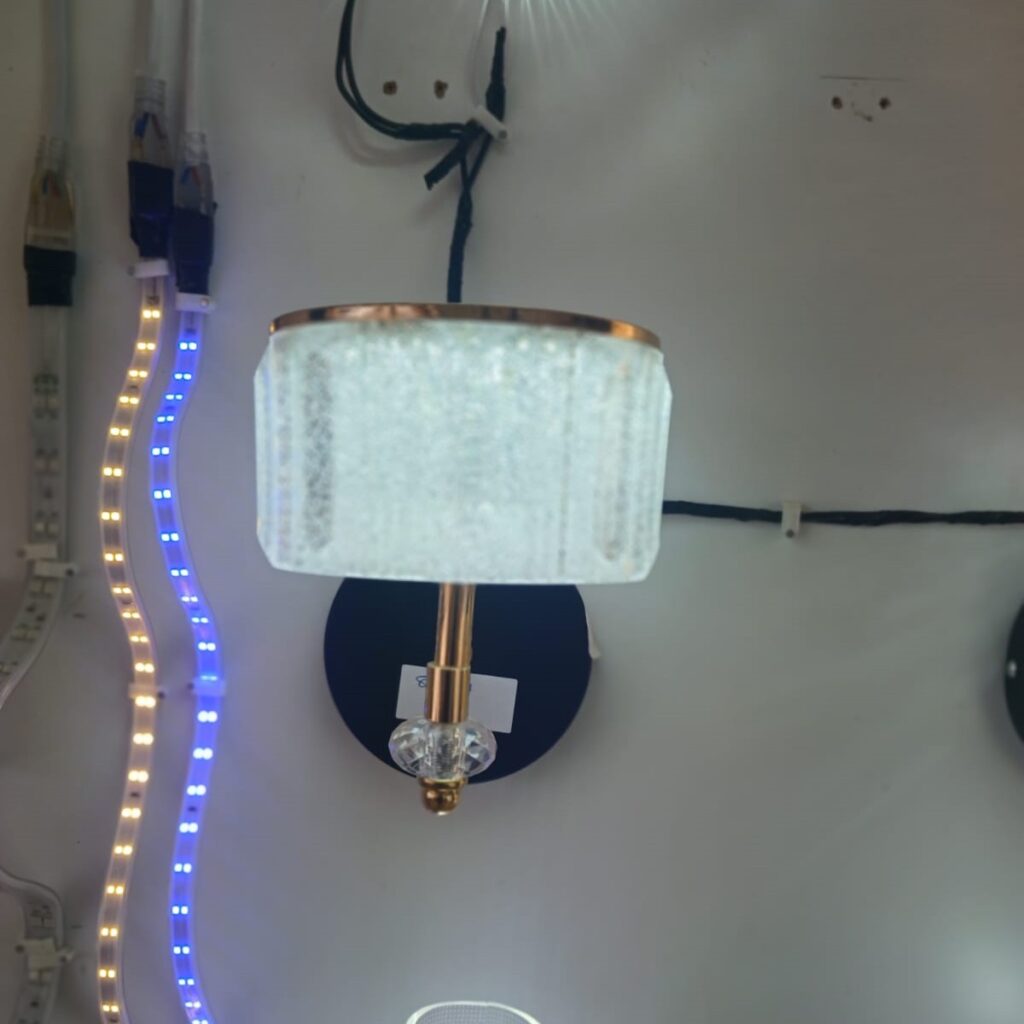 Modern Glass Crystal LED Wall bracket light best prices in Nairobi Kenya Installation: Wall-mounted (Mounting screws and bracket included) Applications: Suitable for Bedrooms, Living Rooms, Hallways, Cafés, Offices Bulb Compatibility: LED and conventional bulbs Lighting Effect: Soft, diffused glow through textured glass Durability: Rust-resistant, heat-tolerant build for long-term use.